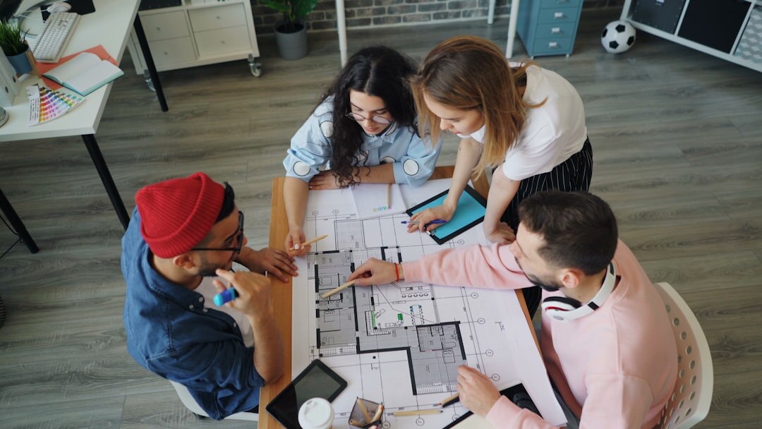 Diverse team of analysts discussing charts around a table