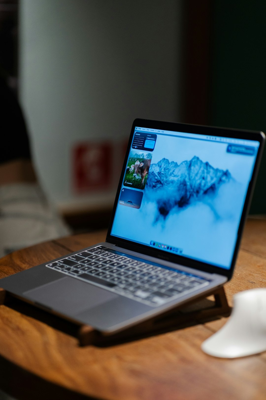 Laptop showing financial charts on a wooden desk